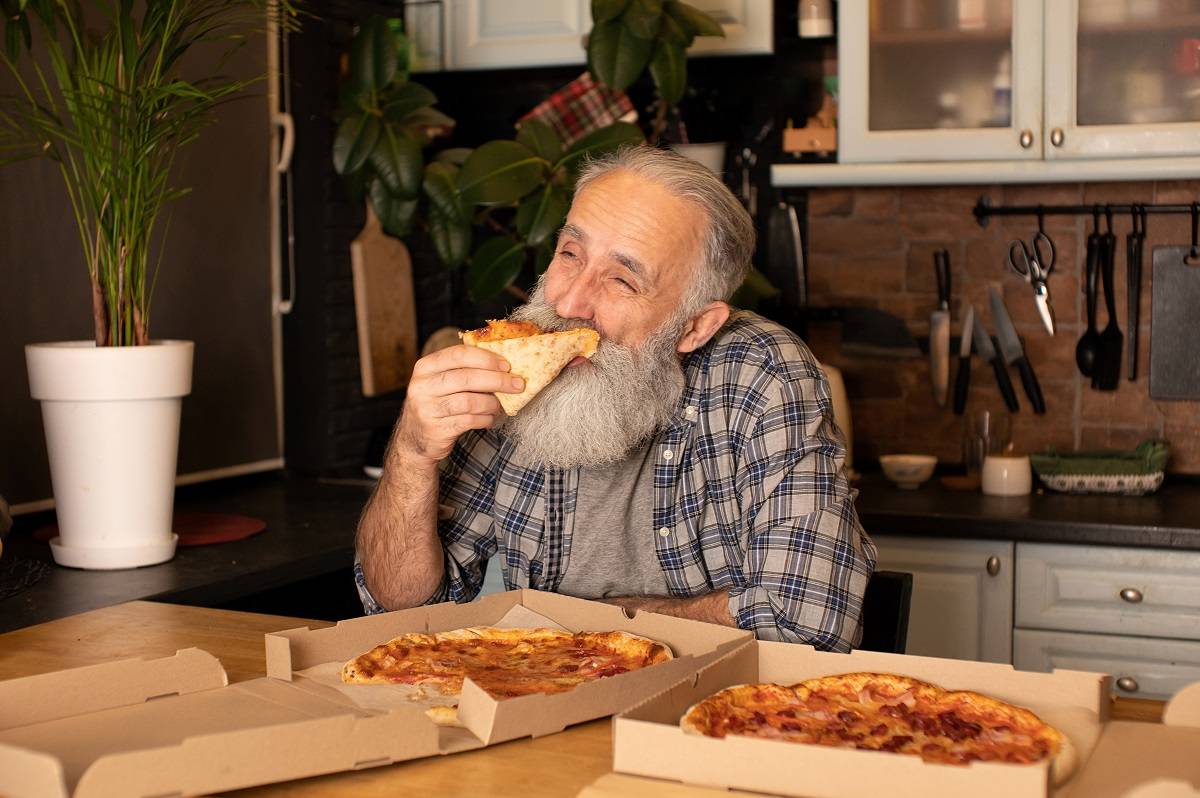 senior man enjoying pizza from papa murphy's senior discount