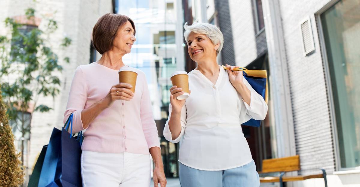 two female seniors with shopping bags and coffee after shopping at ross, senior discount for high-quality clothes